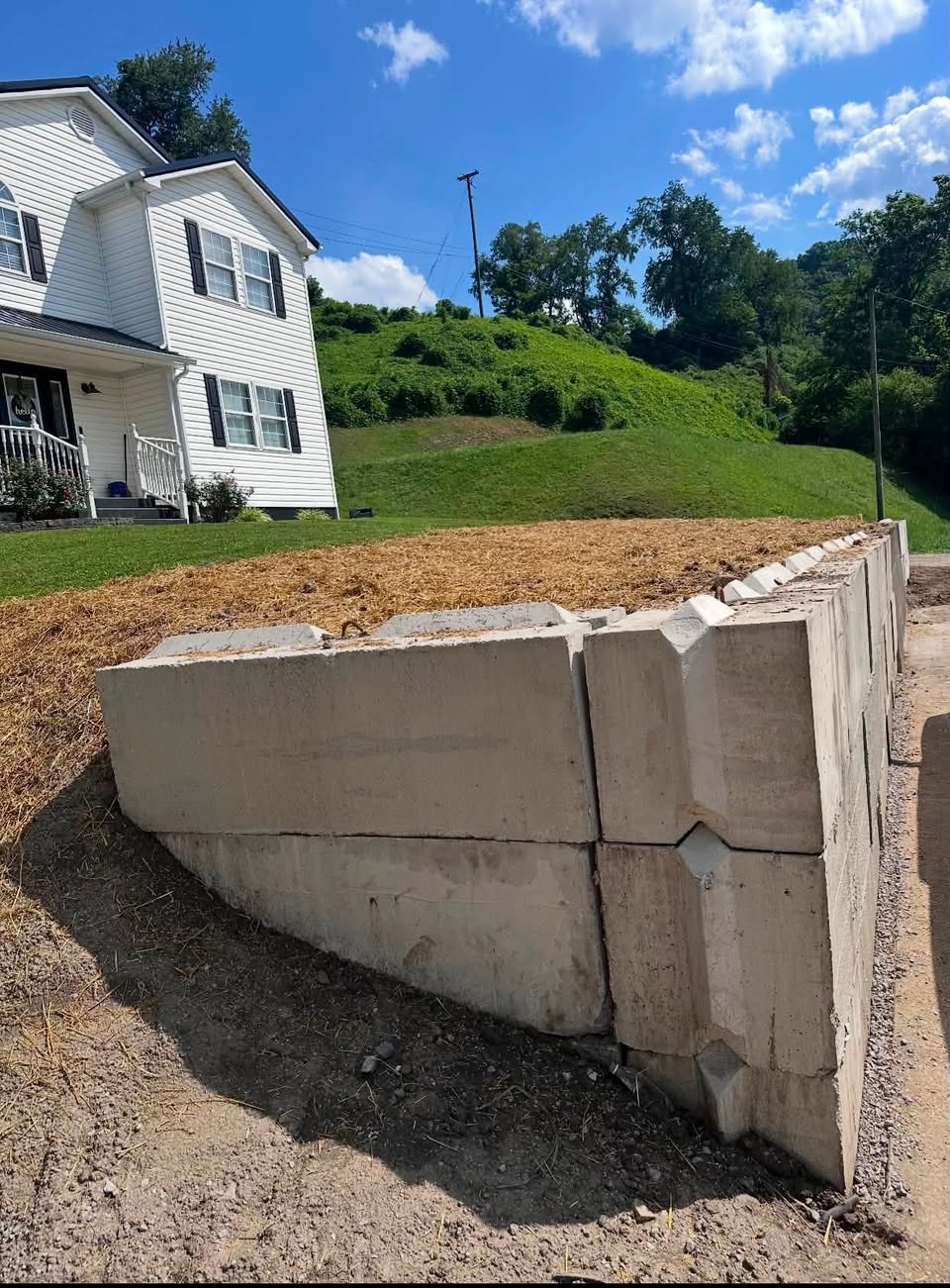 Concrete block retaining wall and graded yard